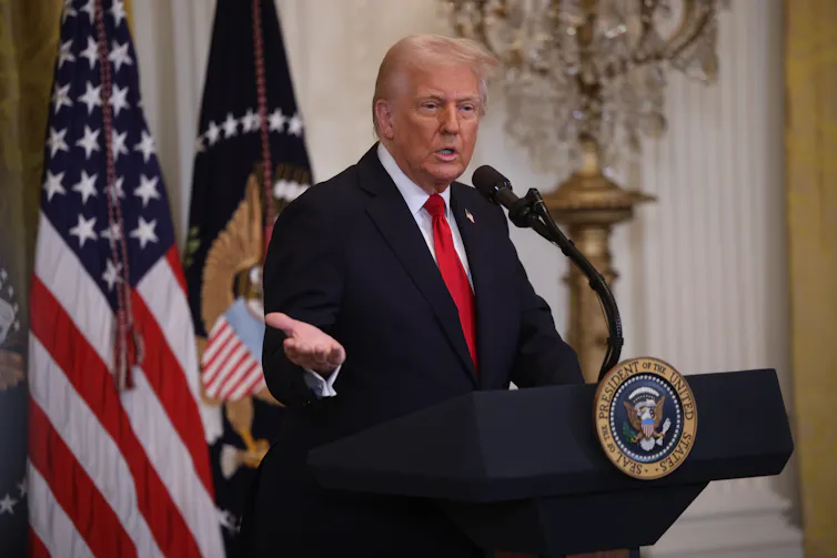 US President Donald Trump speaks at a lectern in the East Room of the White House, march 26 2025.