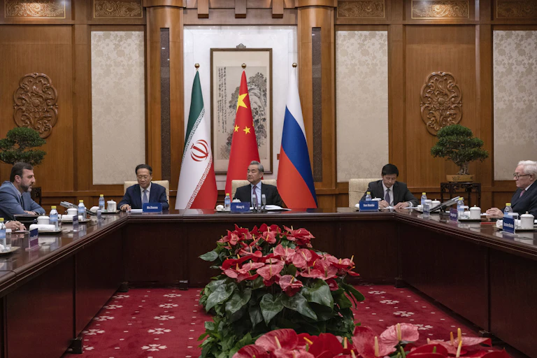 People sit around a large conference table.