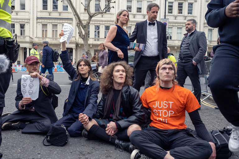 Protesters sit on ground