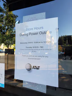 A printed sign on the door of business indicates that it is closed due to loss of power during a Pacific Gas and Electric public safety power shutoff in Lafayette, California, on Oct. 10, 2019.