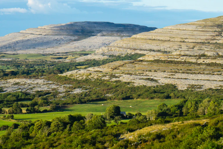 limestone hills with green farmland in foreground