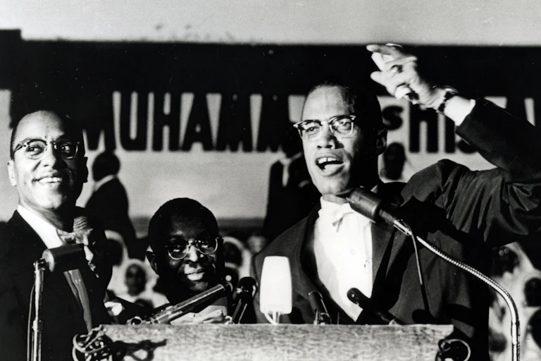 Malcolm X giving a speech.