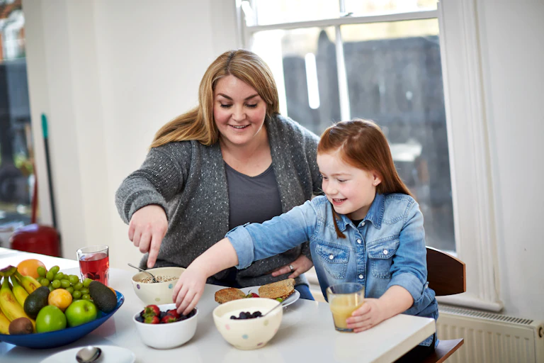 Mother preparing food with daughter