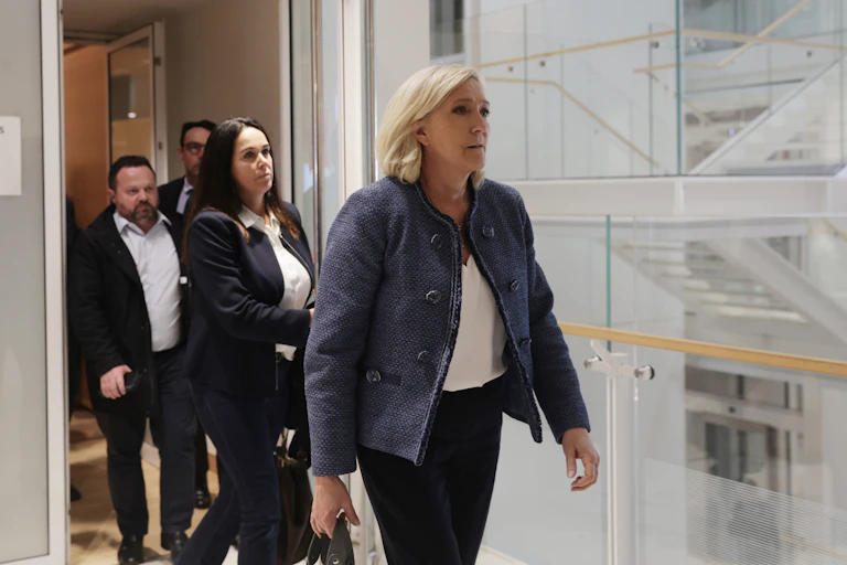 Marine Le Pen walking out of a courtroom.