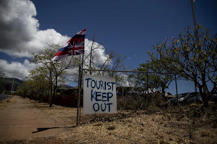 A sign reads 'tourist keep out' at the entrance to a neighbourhood in Hawaii.