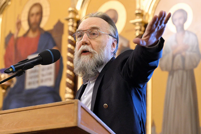 Ultra-nationalist ideologue: Alexandr Dugin, gestures with his left arm while making a speech in a Russian orthodox church. Behind him are religious images.