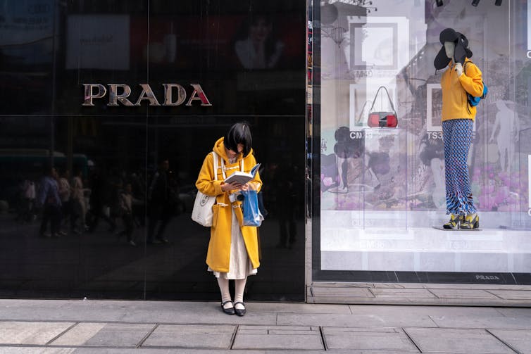 : consumers walking by luxury retail stores in Tai Gu Li and Chengdu IFS shopping district