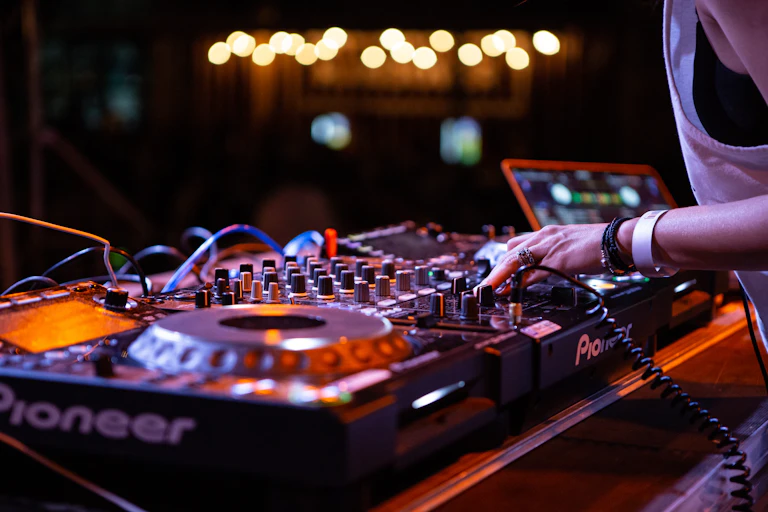 Close up of pair of hands mixing music on a DJ turntable
