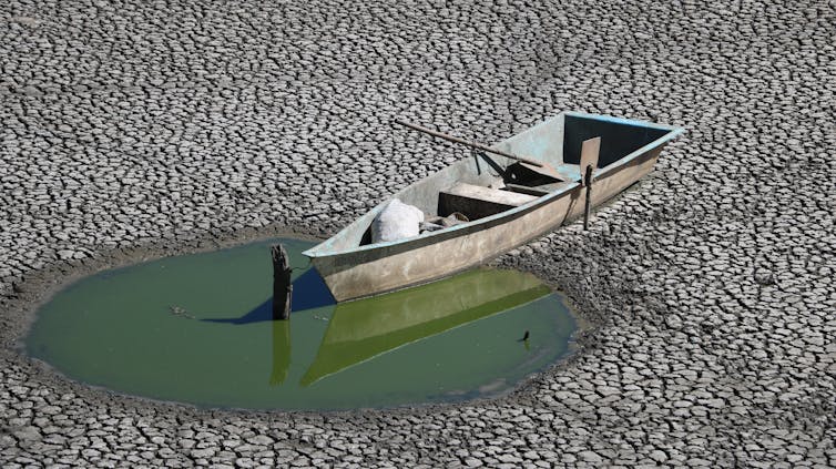small boat run aground near puddle