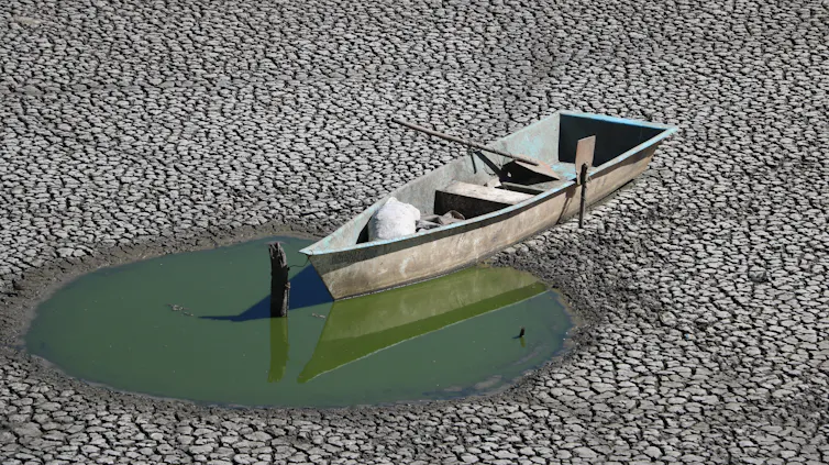 small boat run aground near puddle