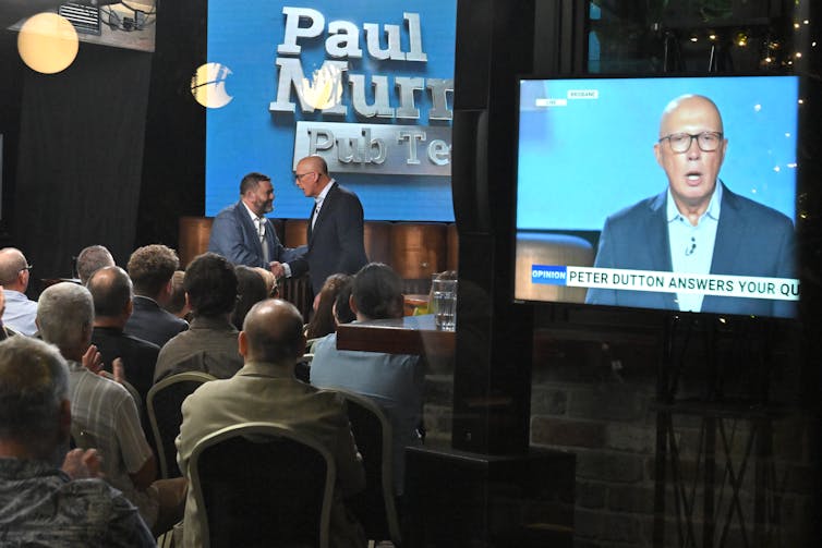 Opposition Leader Peter Dutton greets host Paul Murray in front of a studio audience.