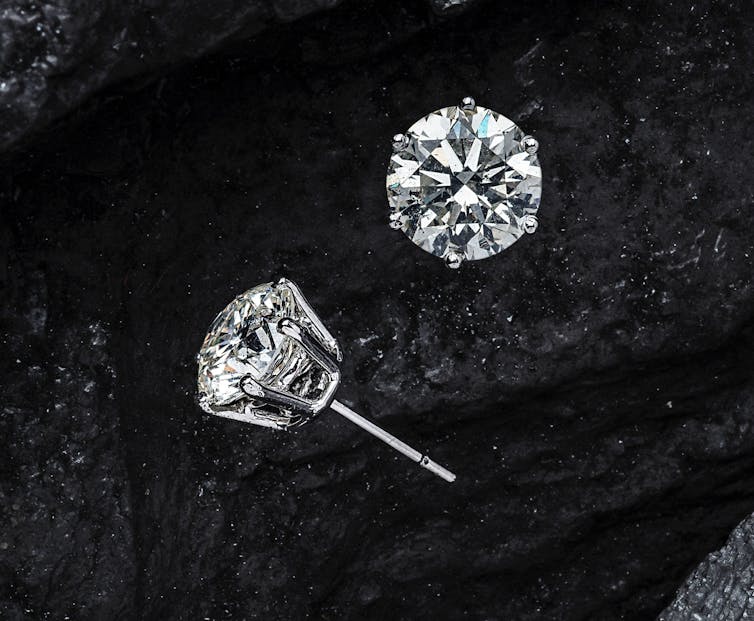 A pair of diamond stud earrings.