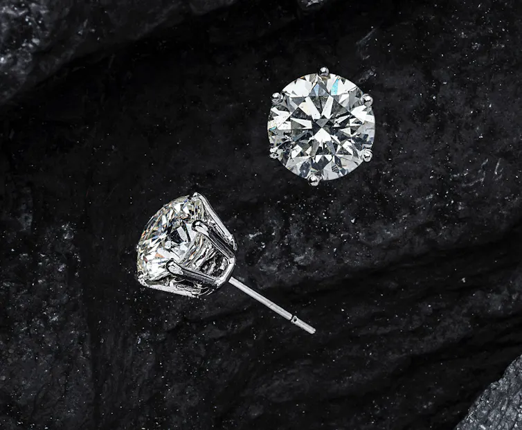 A pair of diamond stud earrings.