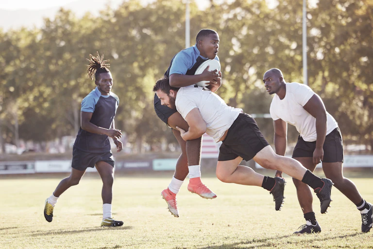Rugby player being tackled.