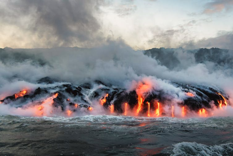 Molten lava flowing into the ocean.