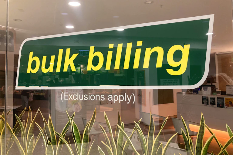 Bulk billing sign on glass of GP surgery