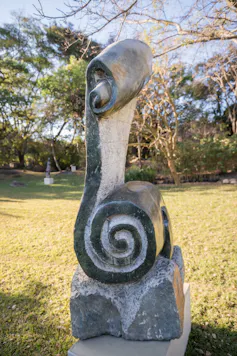 An abstract sculpture with a spiral at the base.
