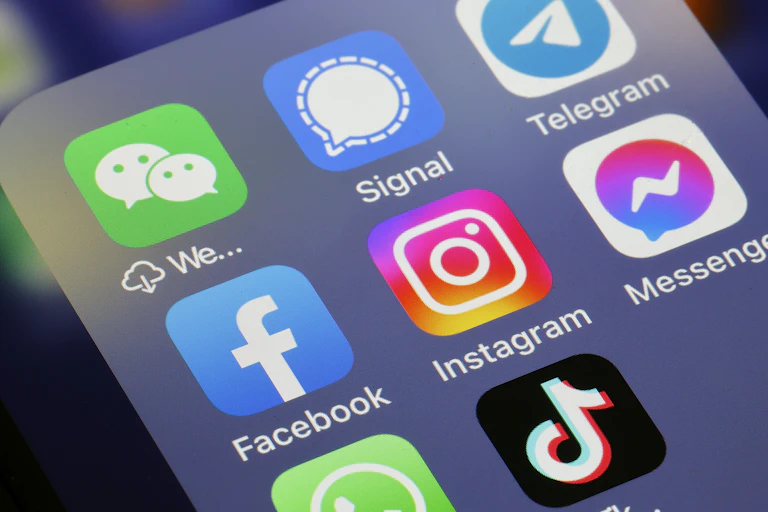 The logos of social media applications Instagram, WhatsApp, Messenger, WeChat, Signal, Telegram, TikTok, Twitter and Facebook are displayed on the screen of an iPhone.