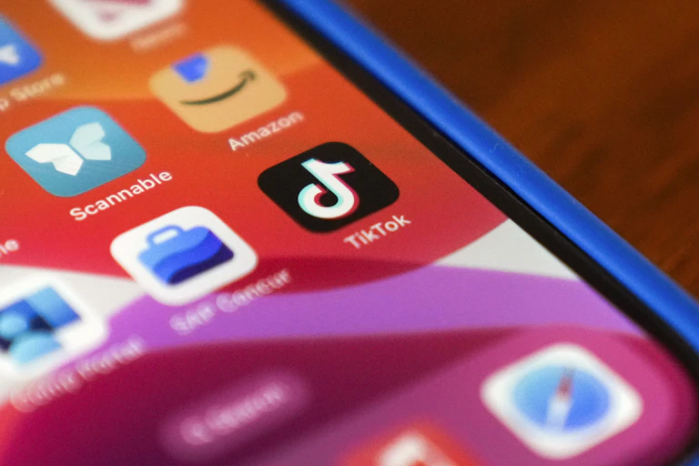 Close up of a smartphone screen displaying the logo of Tiktok Amazon and other apps