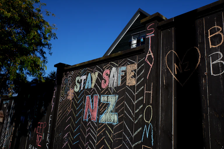 Well wishes in chalk on a residential fence