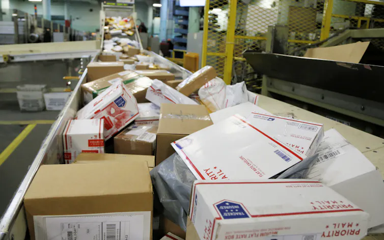 packages travel on a conveyor belt for sorting