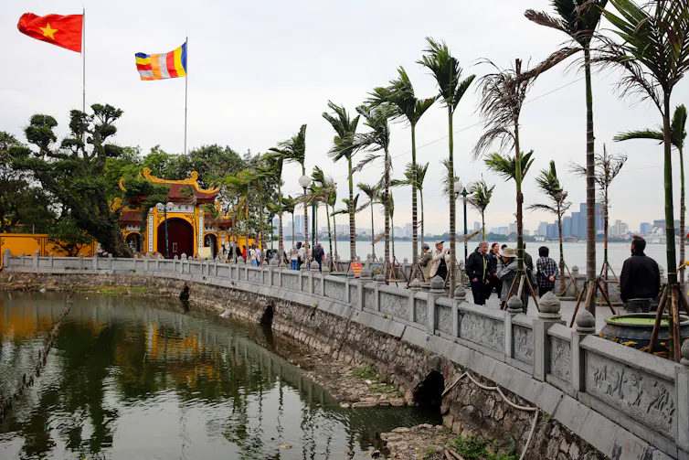 Tourists visiting Tran Quoc pagoda in Hanoi, Vietnam