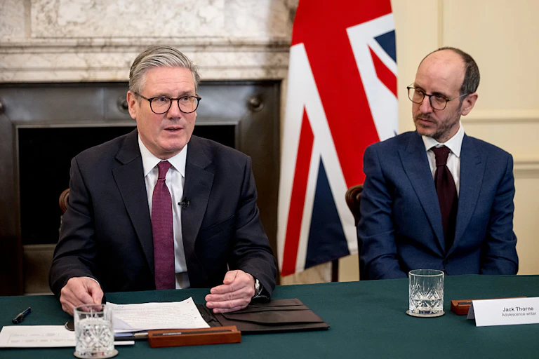 UK Prime Minister Keir Starmer speaks. Writer Jack Thorne looks on.