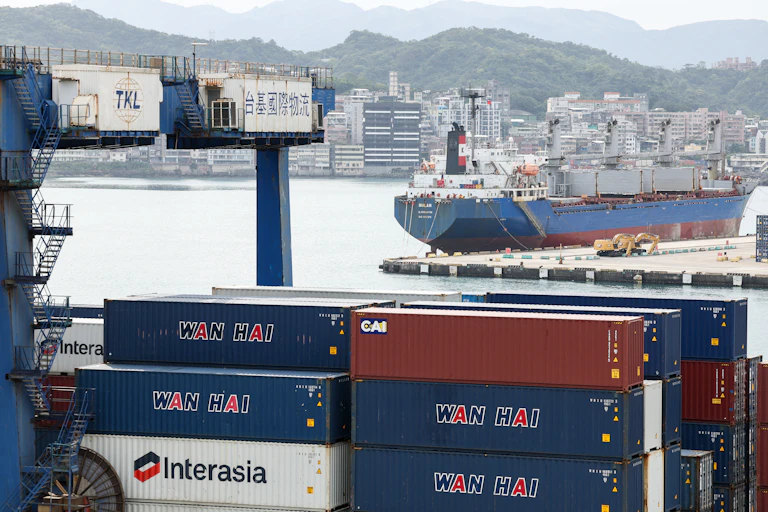 Container ships sit in port.