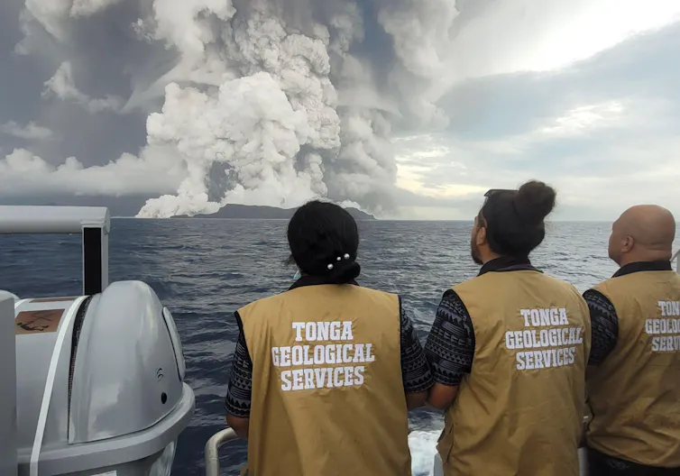 Tonga Geological Services staff looking on at the volcanic eruption in January 2022