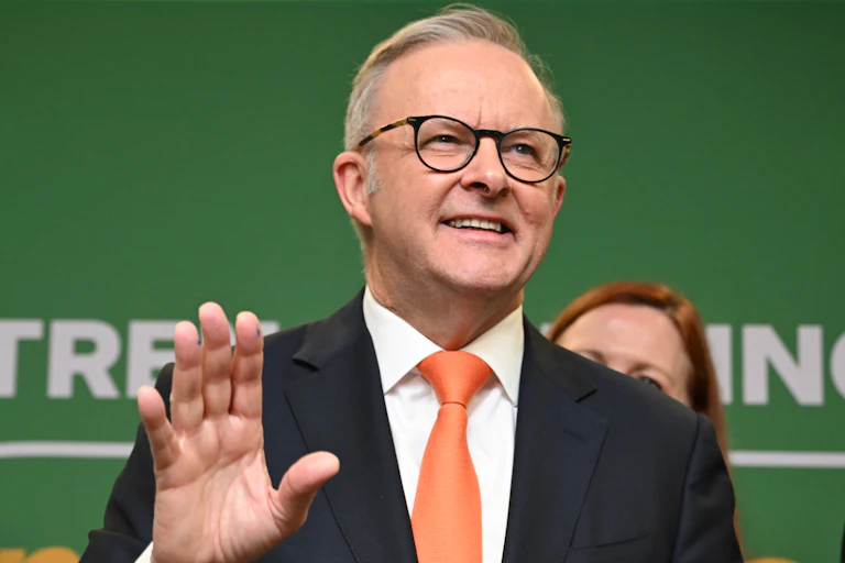 Anthony Albanese smiles in front of a crowd