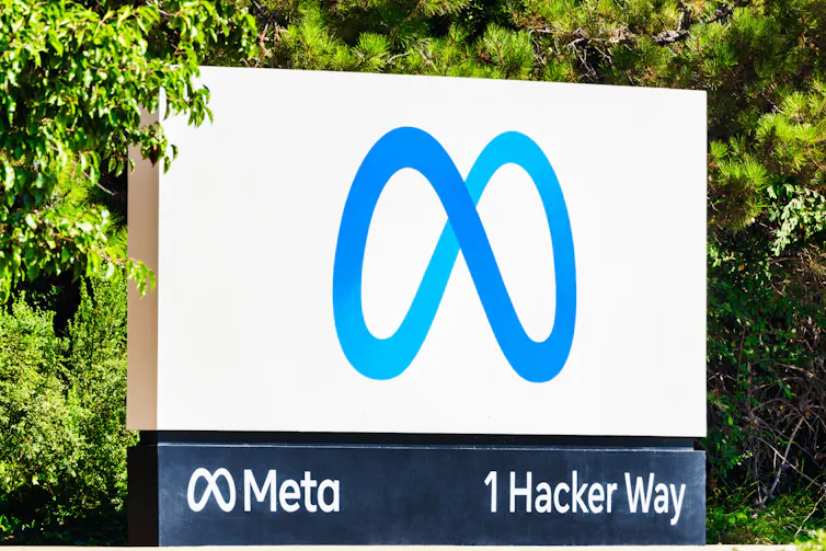 White sign with Meta's blue, figure eight-shaped logo.