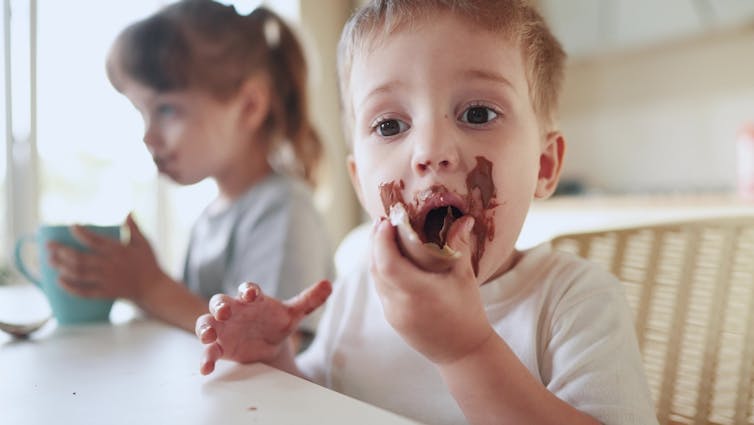 Boy eating Easter chocolate, smeared on face