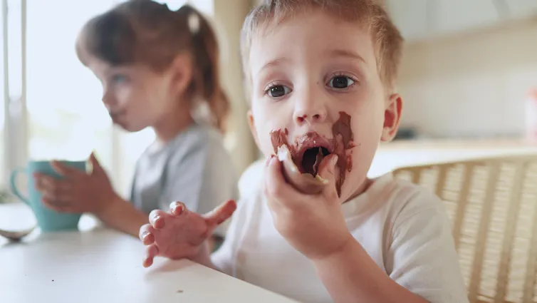 Boy eating Easter chocolate, smeared on face