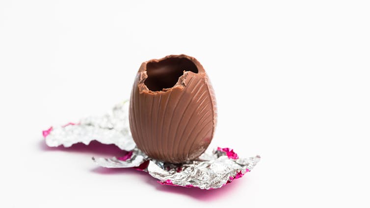 Hollow chocolate Easter egg stting on unwrapped foil