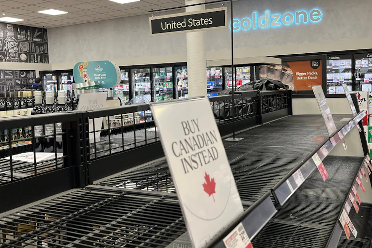 empty shelves in a the US section of a Canadian liquor store.