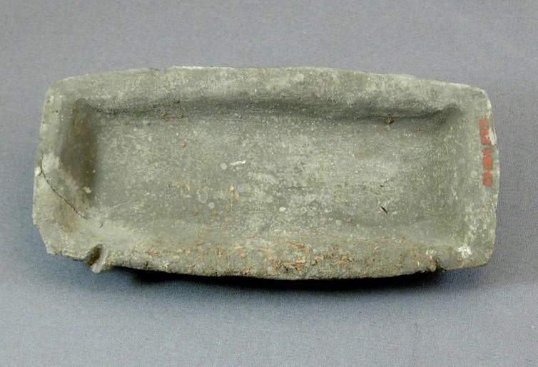 A plain clay tray, in the shape of a modern loaf tin