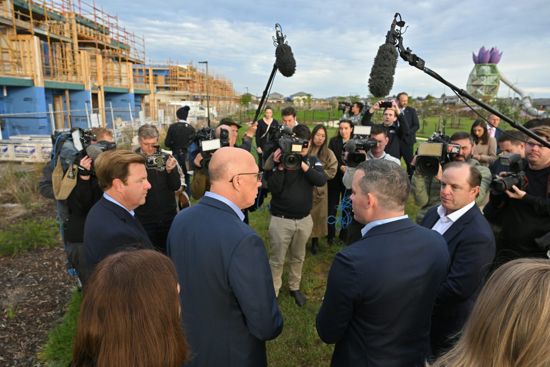 Opposition Leader Peter Dutton and colleagues visit a building site.