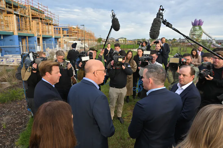 Opposition Leader Peter Dutton and colleagues visit a building site.