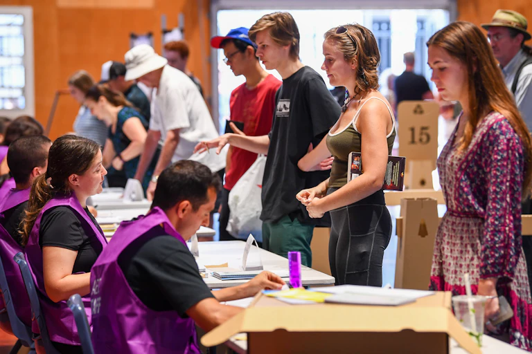 Young voters line up to get their ballot papers.