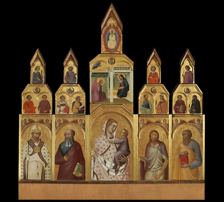 Altar piece in gold with several panels showing different saints. In the middle are the virgin Mary and Christ.