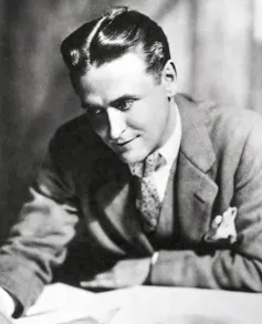 F. Scott Fitzgerald writing while wearing a suit.