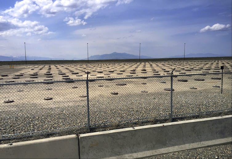 A vast open space spreads in front of a distant mountain range