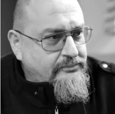 A middle-aged man with a tufted beard.