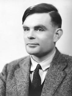 Black and white portrait of a man with a combover wearing a suit.