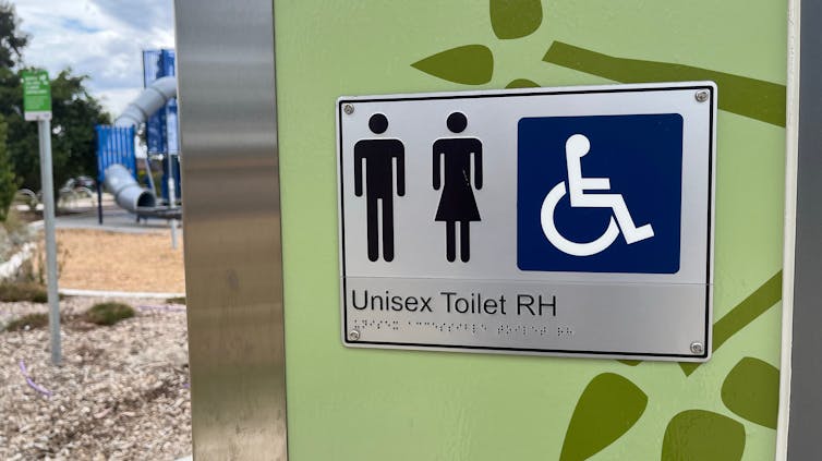 A public toilet block sits in a Victorian park.