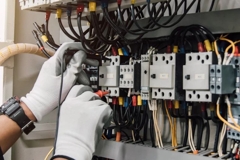 Electrician tests installation and wires