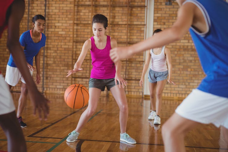 Teenagers playing basketball