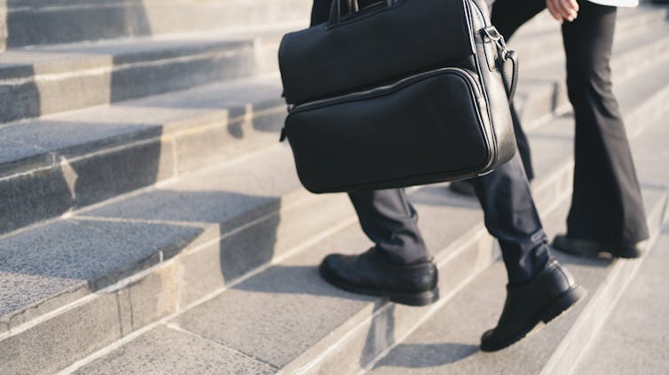 closeup of business people walking up stairs