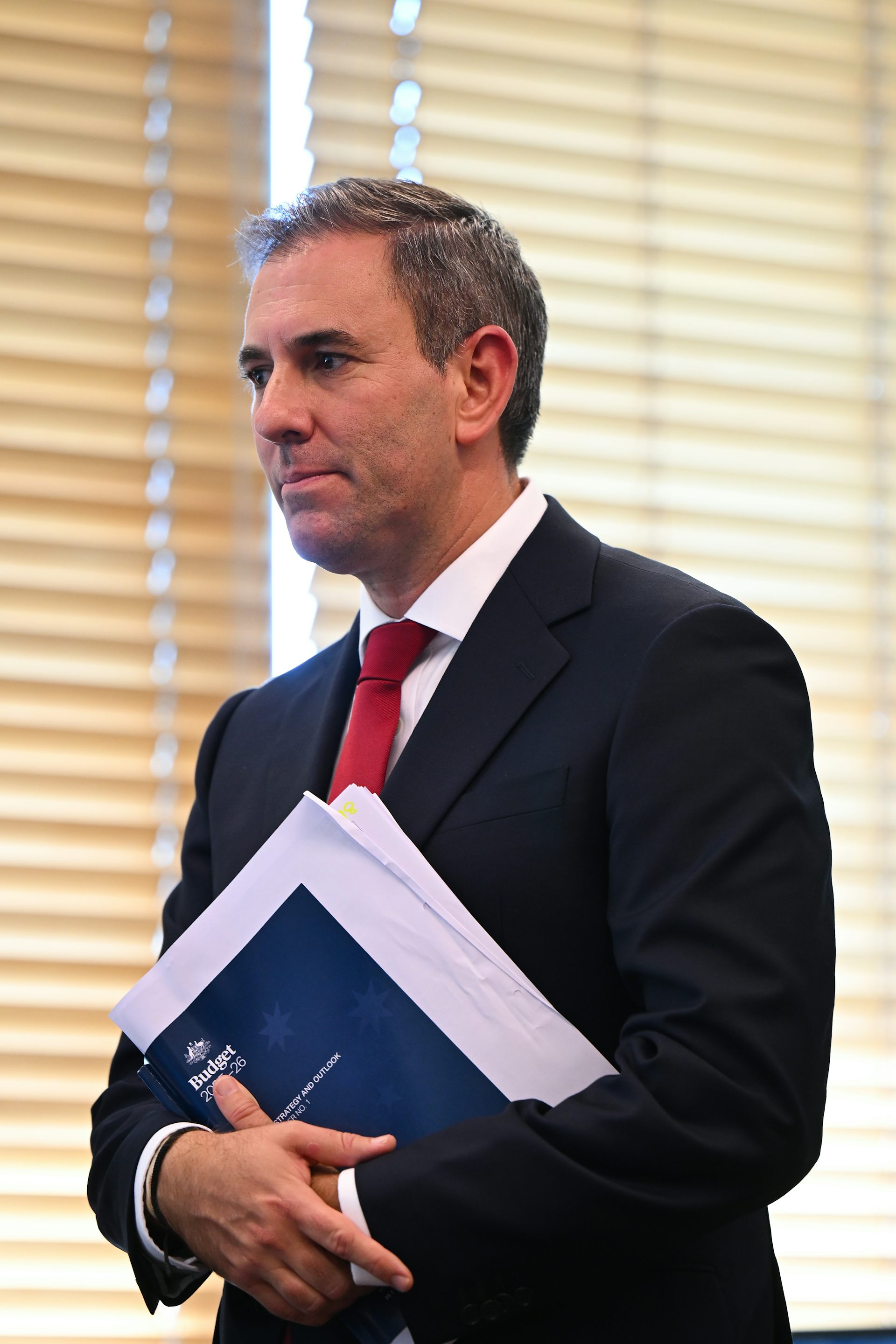 Australian Treasurer Jim Chalmers holding budget documents