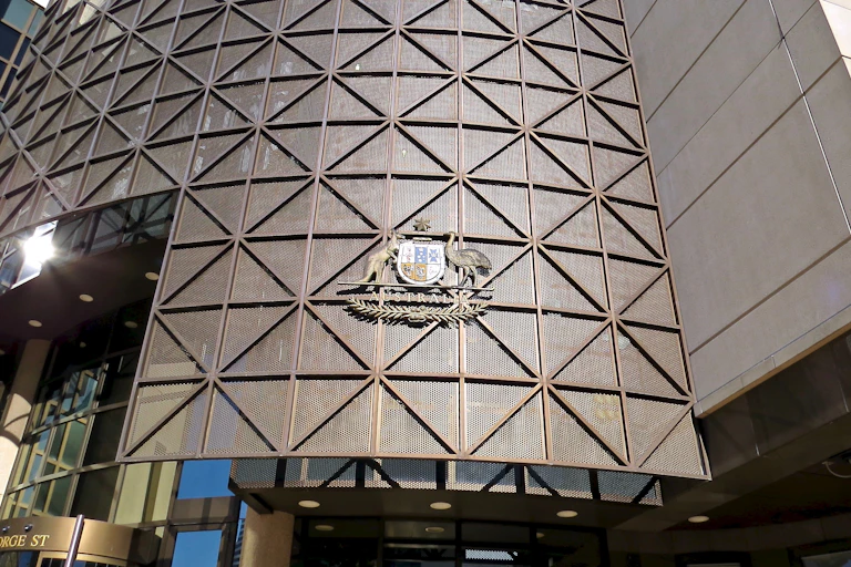 The metal exterior of a building with an Australian coat of arms